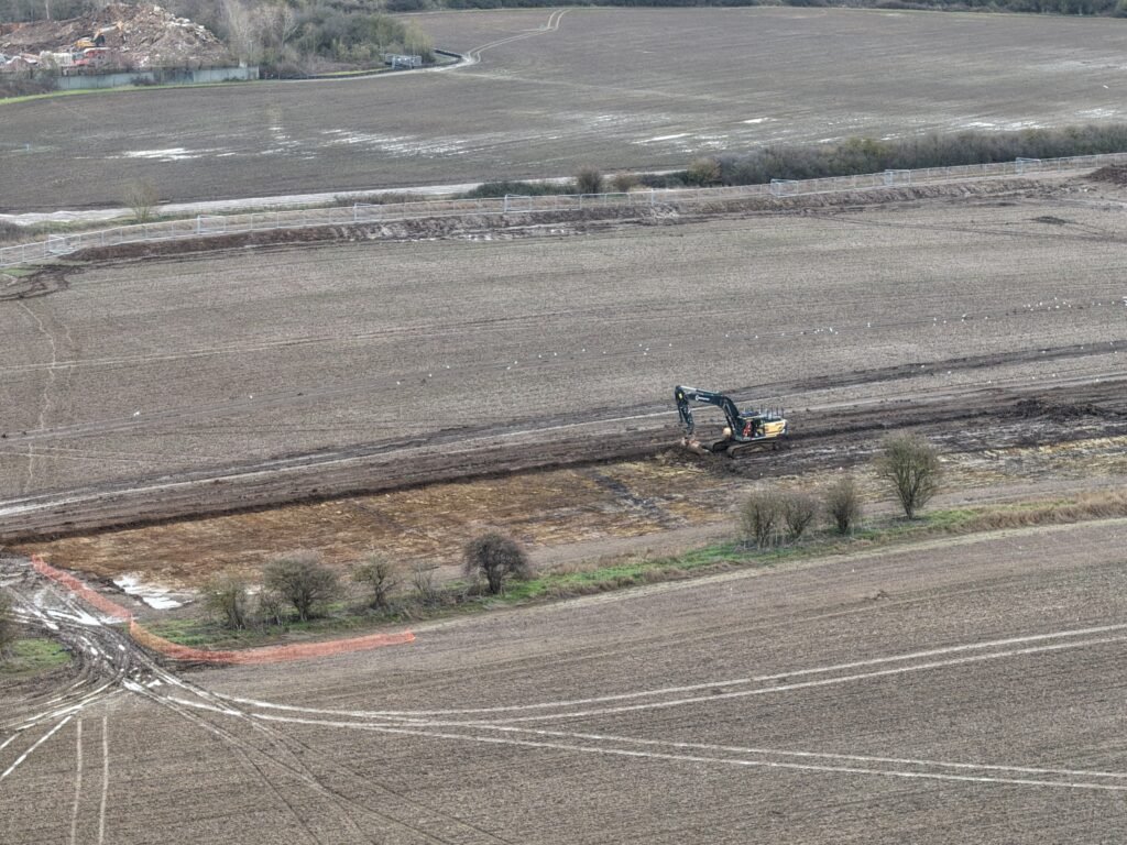 An excavator in Core Zone archaeology works January 2026
